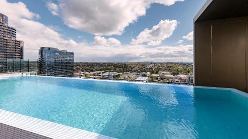 a large swimming pool on top of a building at Avani Melbourne Box Hill Residences in Box Hill