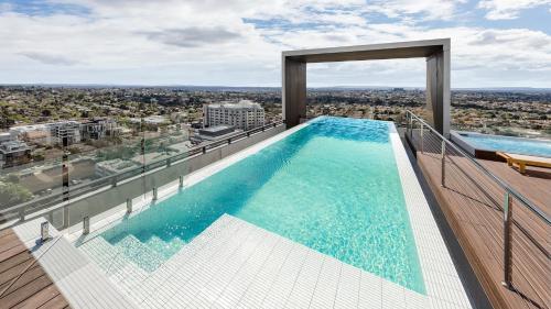 a swimming pool on the top of a building at Avani Melbourne Box Hill Residences in Box Hill