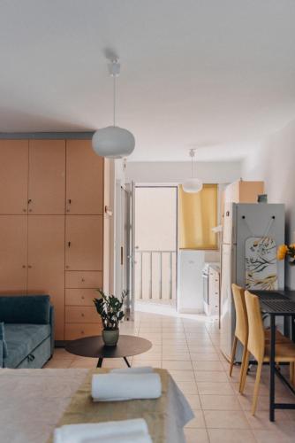a kitchen and living room with a couch and a table at Best House, Nirvana II, Patra in Patra