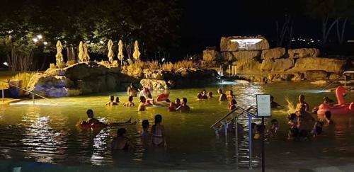a group of people in the water at a water park at Tuscania Terme Suites Apartments in Tuscania