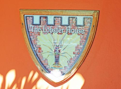 a sign on a house with a spider on it at Sunrise Club Hotel in Negril