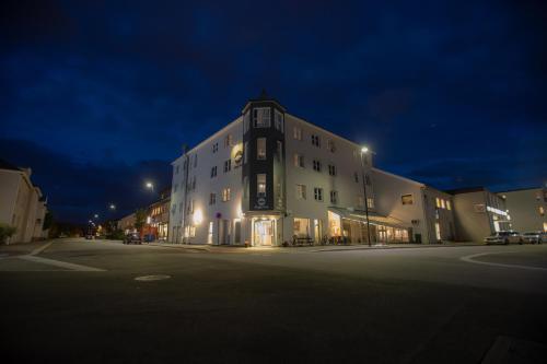 a large building with a clock on the side of it at Thon PartnerHotel Skagen in Bodø