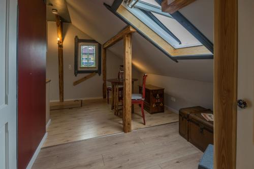 an attic room with a skylight and a table at Ferienwohnung „Kleine Liebe“ in Bad Schandau