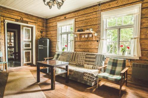 a living room with a couch and a table at Pagulbis - Tavo namai in Klabiniai