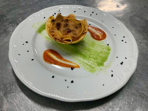 a white plate with a plate of food on a table at Hotel Mamiani & Relaxing Spa Urbino in Urbino