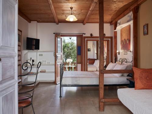 a bedroom with two beds and a television in it at Polikandia Hotel in Chora Folegandros