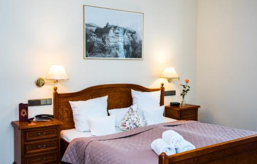 Ένα ή περισσότερα κρεβάτια σε δωμάτιο στο Hotel Rezydencja