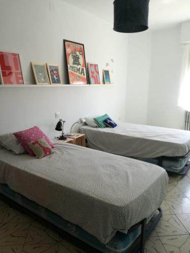 two twin beds in a room with at Casa Oroela in Jaca