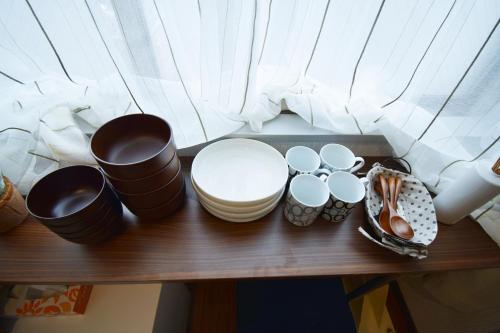 a table with bowls and plates on top of it at 3 min to Komagome Sta by foot/15min to Shinju&Tokyo Sta by JR in Tokyo