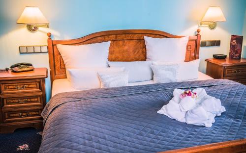 Ένα ή περισσότερα κρεβάτια σε δωμάτιο στο Hotel Rezydencja