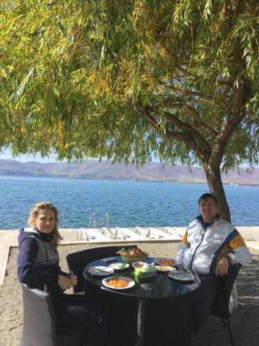 a man and woman sitting at a table with food at EDEM SEVAN in Sevan