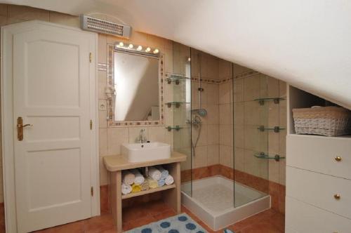 a bathroom with a sink and a shower with a mirror at Deluxe Villa Sirena on the beach with Pool in Supetar