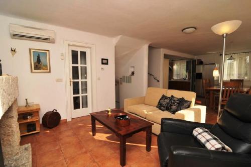 a living room with a couch and a coffee table at Deluxe Villa Sirena on the beach with Pool in Supetar