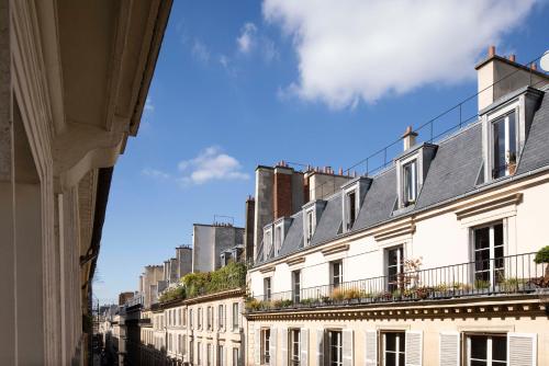 a row of white buildings on a city street at Hotel Duminy-Vendome in Paris