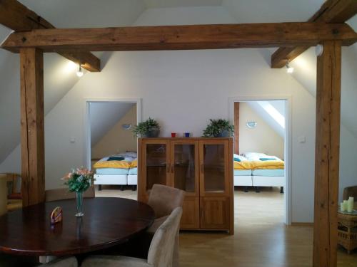a dining room with a table and two beds at Camping & Guest House Pliskovice in Mirovice