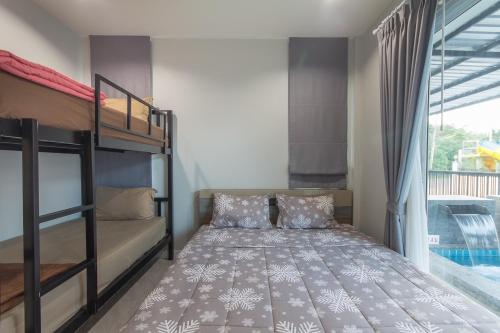 a bedroom with two bunk beds and a window at SEA Villa Hua Hin in Hua Hin