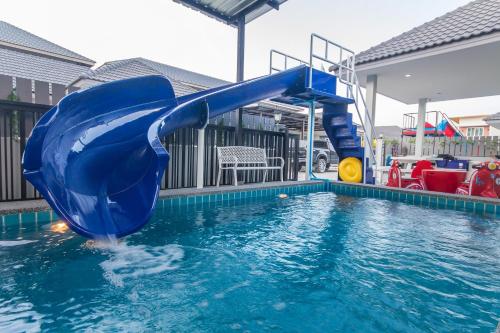 a blue water slide in a swimming pool at SEA Villa Hua Hin in Hua Hin
