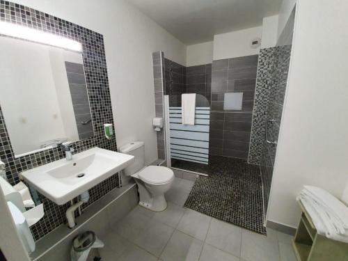 a bathroom with a sink and a toilet and a shower at Kyriad Saint Fargeau Ponthierry - Apollonia in Saint-Fargeau-Ponthierry