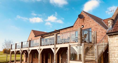 an external view of a brick building with glass windows at The Players Golf Club in Bristol