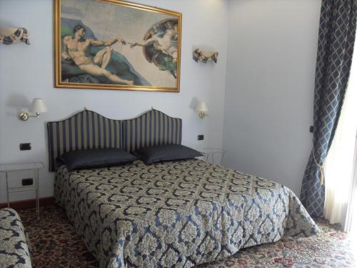 a bedroom with a bed and a painting on the wall at Da Betty in Asti