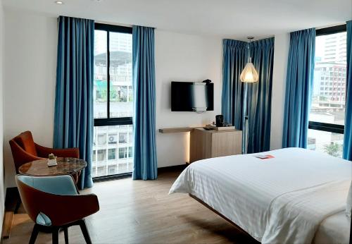 מיטה או מיטות בחדר ב-Sacha's Hotel Uno SHA
