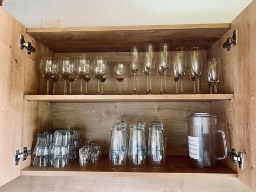 a row of wine glasses sitting on a shelf at Astegger Talhof in Finkenberg