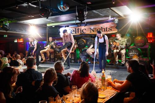 a group of people watching a band on stage at Arlington Hotel O'Connell Bridge in Dublin