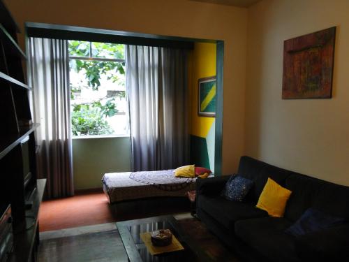 a living room with a couch and a window at Copacabana apartment with a living room and 2 sleeping rooms in Rio de Janeiro