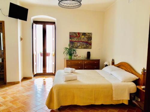 a bedroom with a large bed with towels on it at San Michele delle grotte BnB in Gravina in Puglia