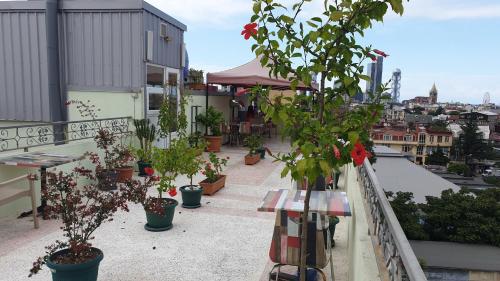 a balcony with potted plants on a building at Marani Hotel in Batumi