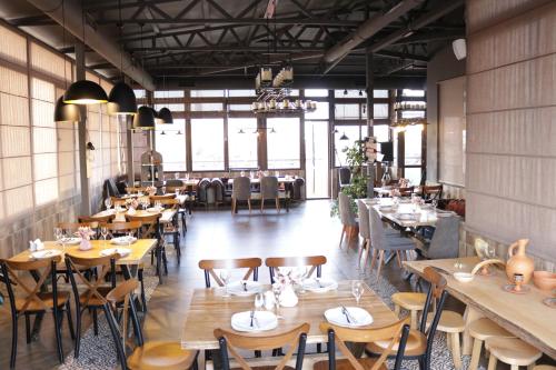 a dining room with wooden tables and chairs at Marani Hotel in Batumi