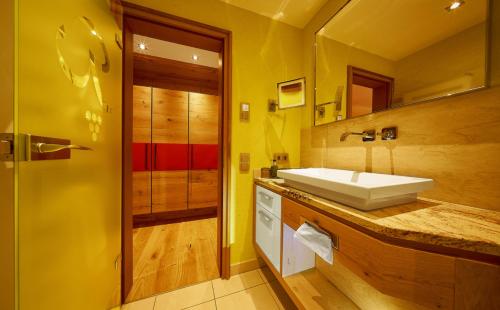 a bathroom with a sink and a mirror at Hotel Rebstock Durbach in Durbach