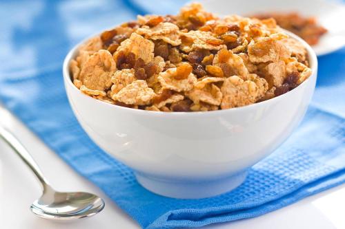 a bowl of apple crisp on a blue napkin with a spoon at Travelodge by Wyndham Worland in Worland