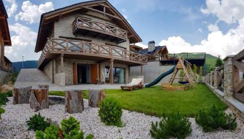 a house with a playground with a slide at Chalet Rebeca 12 beds Donovaly in Donovaly