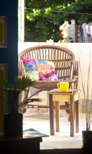 a wooden bench with a colorful pillow and a table at Hostel Gandhi in Chennai