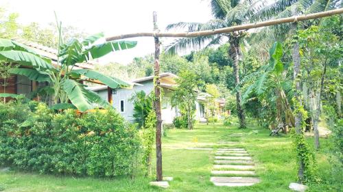 a garden with a path leading to a house at Home No.9 in Ko Lanta