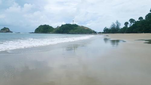an empty beach with a few islands in the water at Home No.9 in Ko Lanta