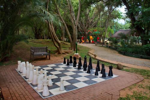 a chess board on a brick path in a park at Kruger Park Lodge Unit No. 608B in Hazyview
