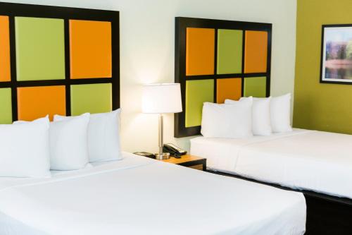 two beds sitting next to each other in a hotel room at The Flagler Inn - Saint Augustine in Saint Augustine