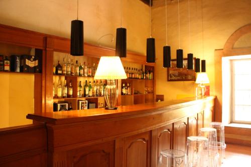 a bar with a long wooden counter with stools at Hacienda Historica Marchigue in Marchihue