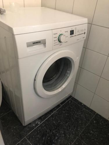 a white washer and dryer in a bathroom at Ferienwohnung Amperblick Fürstenfeldbruck in Fürstenfeldbruck