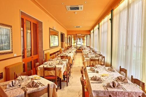 a row of tables in a dining room at Albergo Nazionale in Salsomaggiore Terme