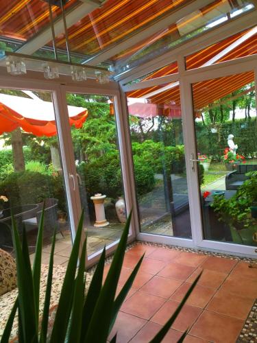 a screened in porch with sliding glass doors at Arena Stadt München in Munich