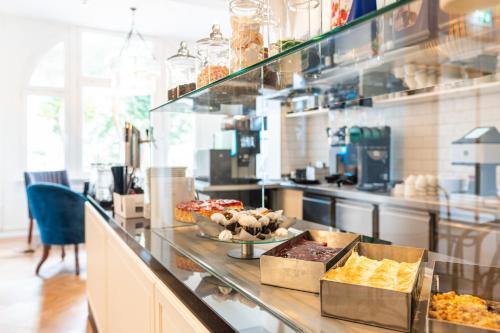 a kitchen with a counter with some food on it at Strandhotel Ahlbeck in Ahlbeck