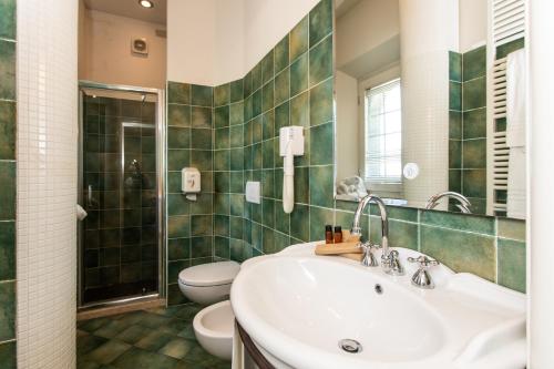 a bathroom with a sink and a toilet at Quel Castello di Diegaro in Cesena