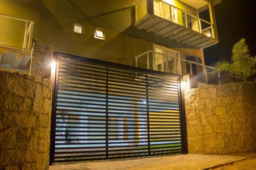 a building with a large garage door at night at Pousada Las Piedras in Praia do Rosa