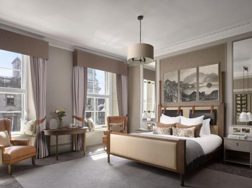 a bedroom with a bed and a desk and a chair at InterContinental Hotels - Edinburgh The George, an IHG Hotel in Edinburgh
