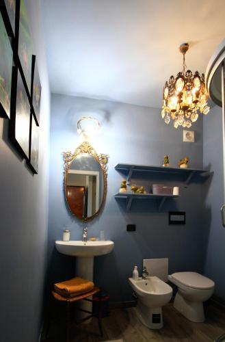 a bathroom with a sink and a mirror and a toilet at B&B La Fenice sul Lago in Villongo SantʼAlessandro