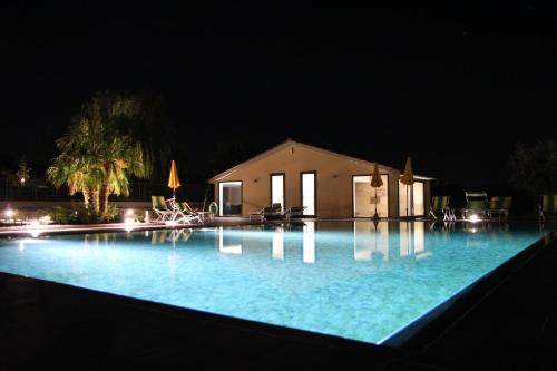 a large swimming pool at night with a building at Agriturismo Verbena in Castiglione del Lago