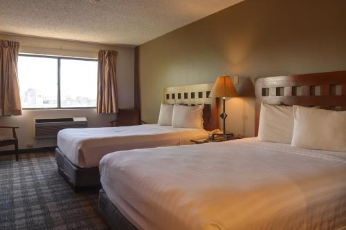 a hotel room with two beds and a window at GreenTree Inn Albuquerque North I-25 in Albuquerque